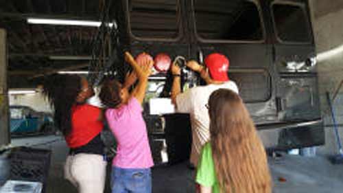 DHS Students painting school bus